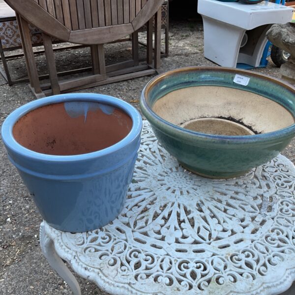 Blue and green glazed terracotta plant pots for garden display.