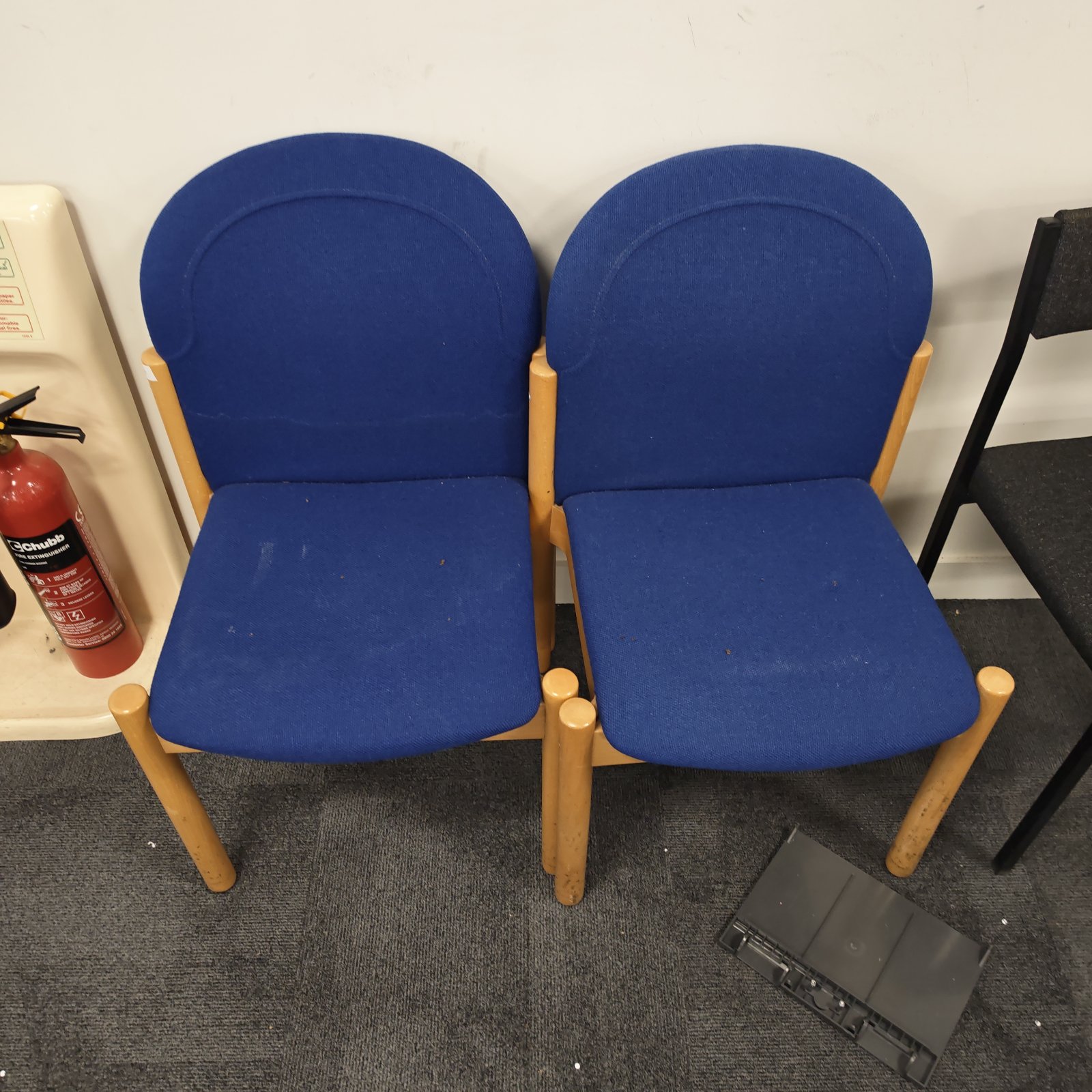 Pair of blue upholstered wooden office reception chairs.