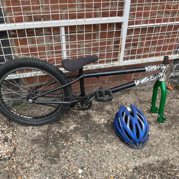 Black BMX bike with Mongoose forks and Boardman helmet.