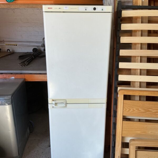 Vintage Bosch fridge freezer in a garage setting.
