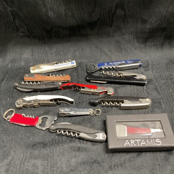 Assorted vintage metal bottle openers in a collectible lot.