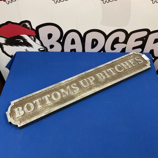 "Bottoms up bitches" wall plaque sign for home bar decor.