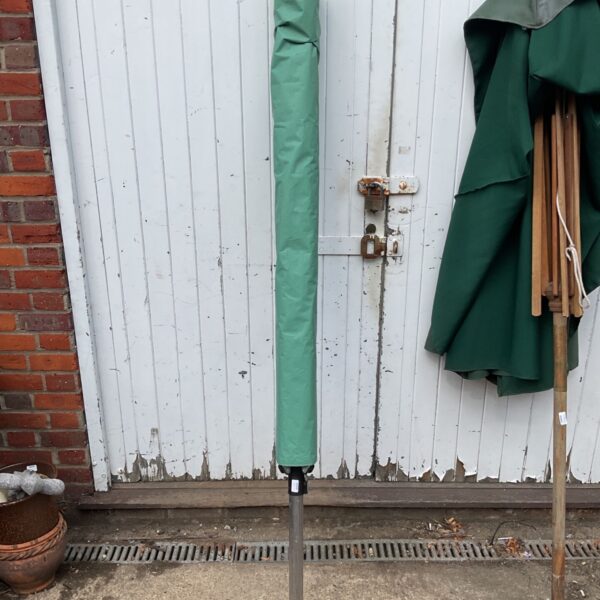Green Brabantia washing rotator in a garden setting.