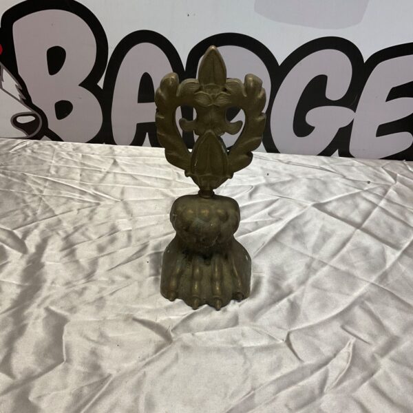 Vintage brass clawfoot door stop for antique home decor.