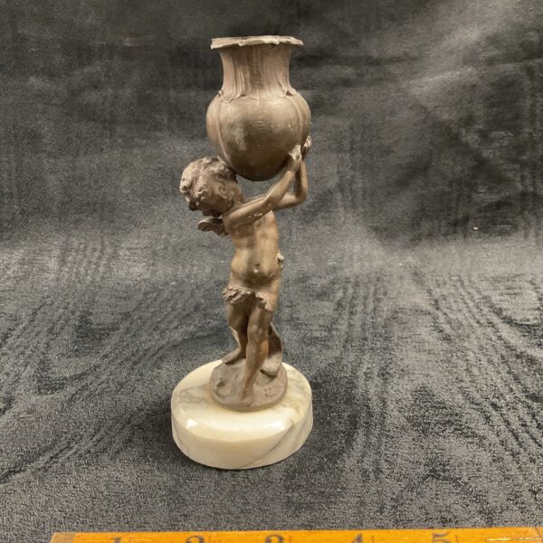 Antique bronze cherub sculpture on a marble base.