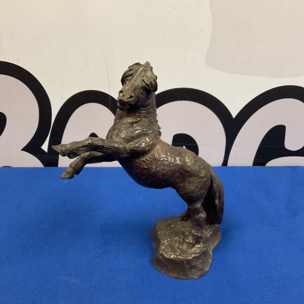 Detailed bronzed resin rearing horse sculpture for collectors.