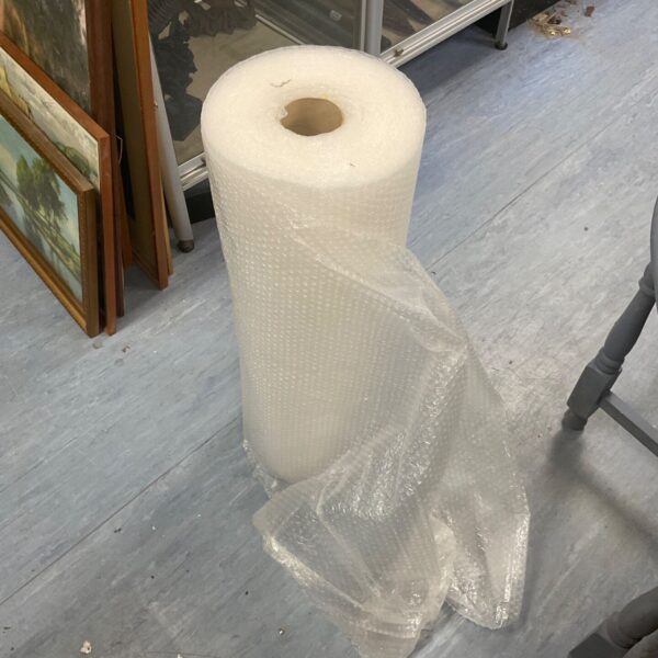 Partially used roll of bubble wrap for protective packaging and shipping.
