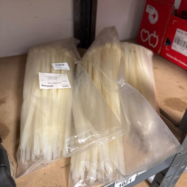 Three packs of white cable ties for wire management and organization.