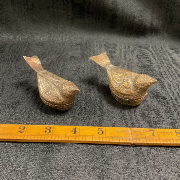 Vintage Cambodian betel nut boxes shaped like birds with repousse detailing.