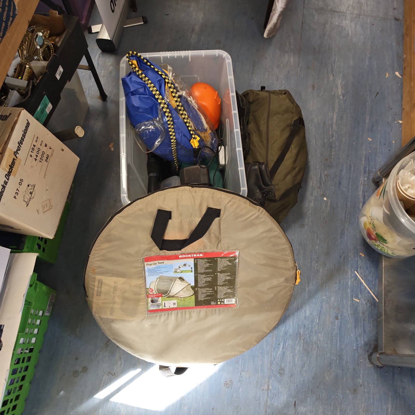 Mixed camping equipment lot including a pop up tent and boots.