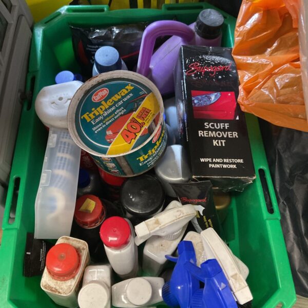 Mixed car detailing kit with polishes, waxes, and cleaning products.