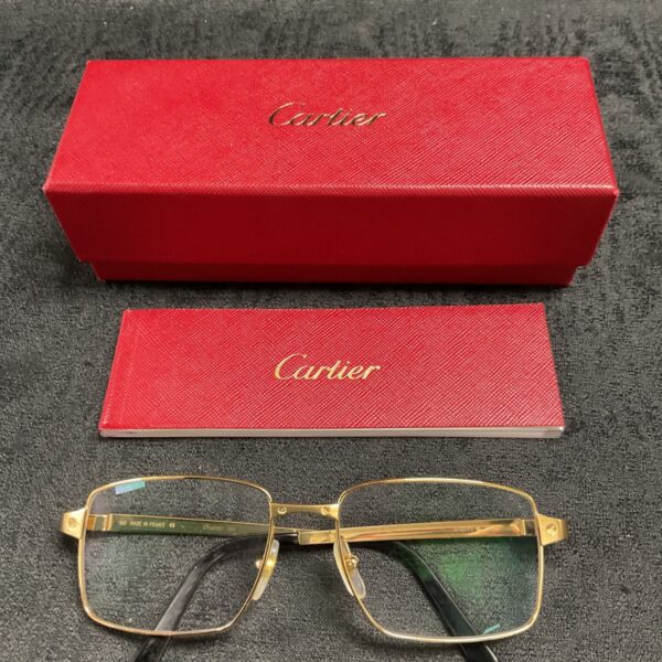 Cartier gold plated glasses with original boxes displayed.