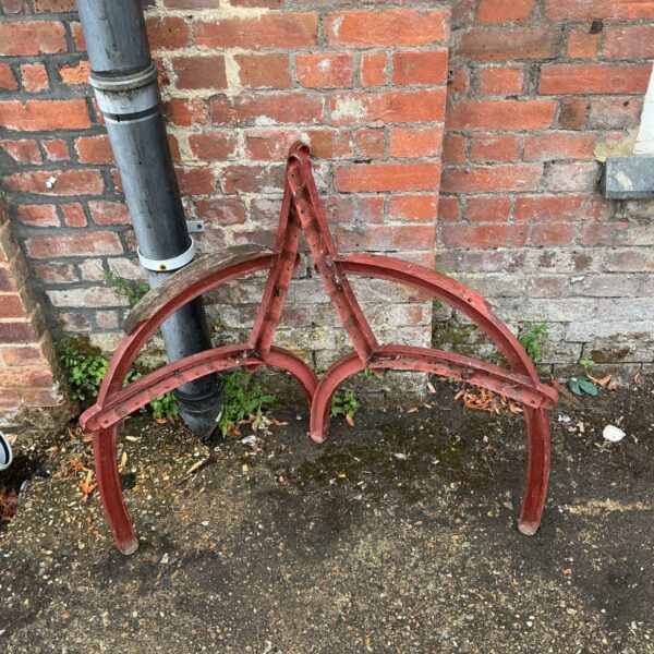 Ornate antique cast iron bench ends with scrolling foliage design.