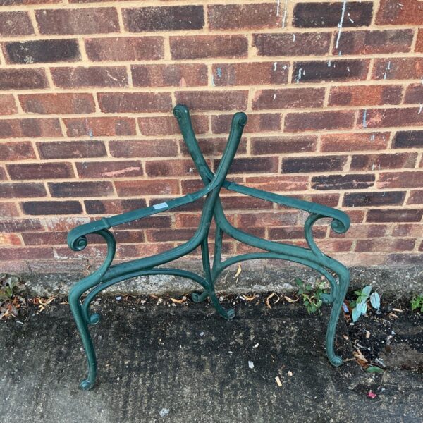 Antique cast iron bench ends in a garden setting.