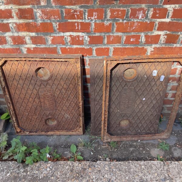 Reclaimed cast iron inspection covers with diamond pattern for grip.