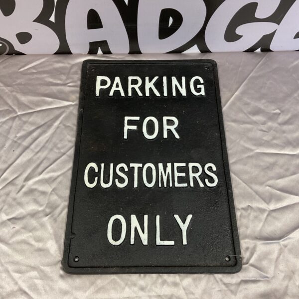 Vintage cast iron parking sign for customers only.
