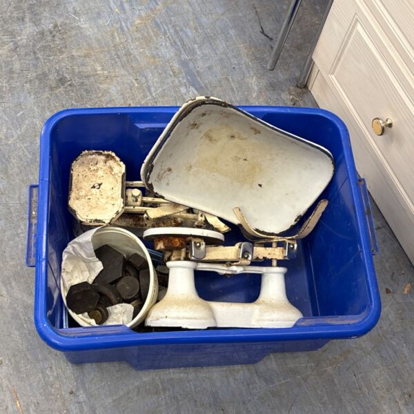 Vintage cast iron scales and weights in a blue box.