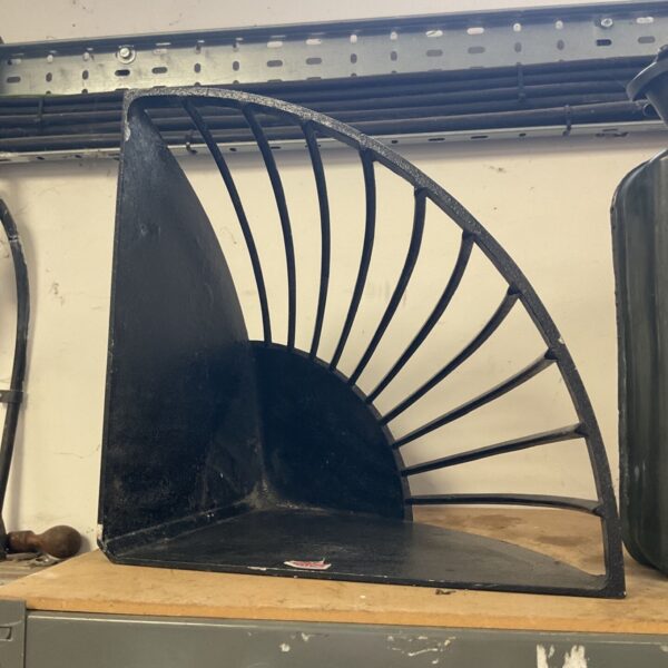 Black cast iron shelf bracket with a sunrise design.