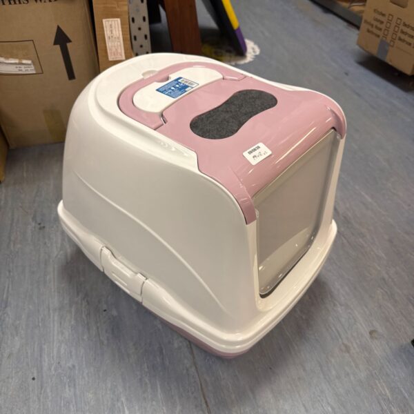 Pink enclosed cat litter tray for pets.
