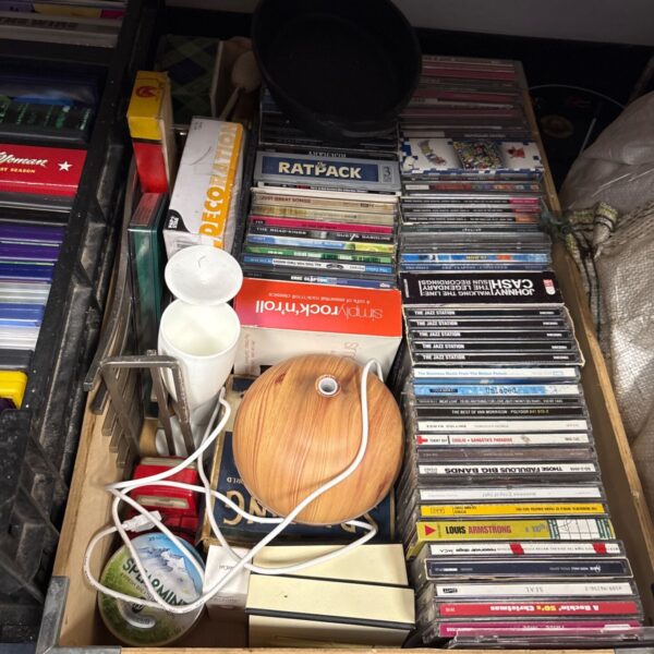Mixed lot of CDs and household items, a diverse collection.