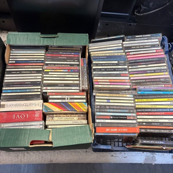 Mixed CD lot with various album covers and music genres.