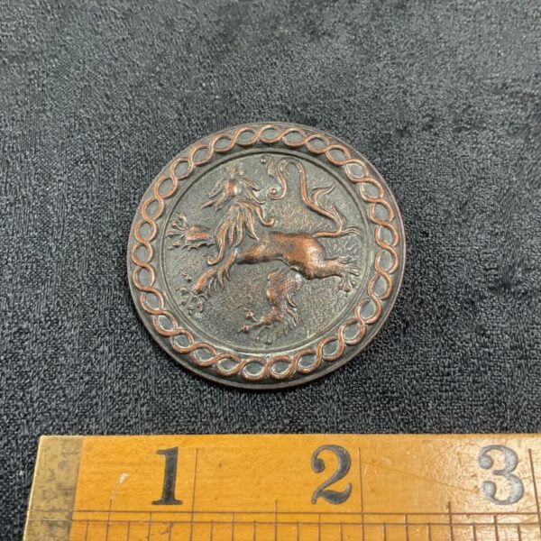 Antique Celtic copper brooch with a sculpted Scottish dragon.