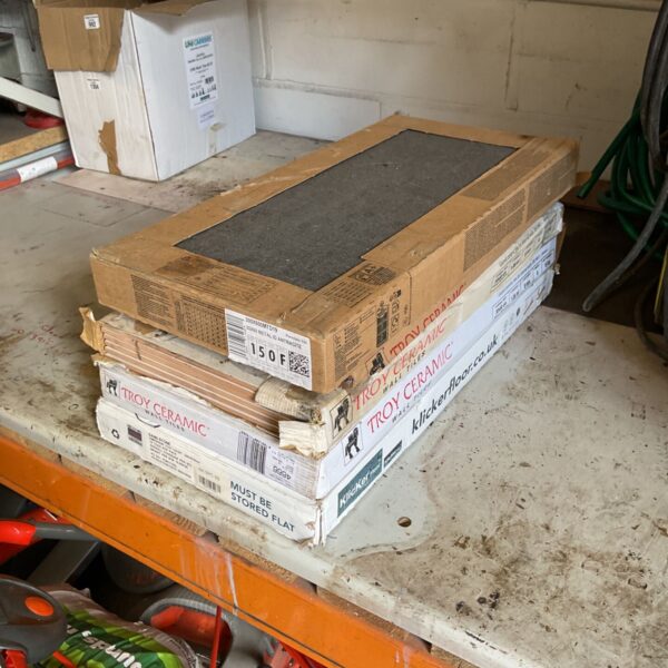 Job lot of assorted ceramic tiles in boxes, ready for tiling projects.
