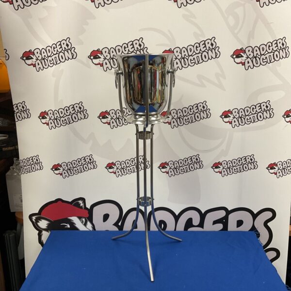 Polished stainless steel champagne bucket on tripod stand at Badgers Auctions.