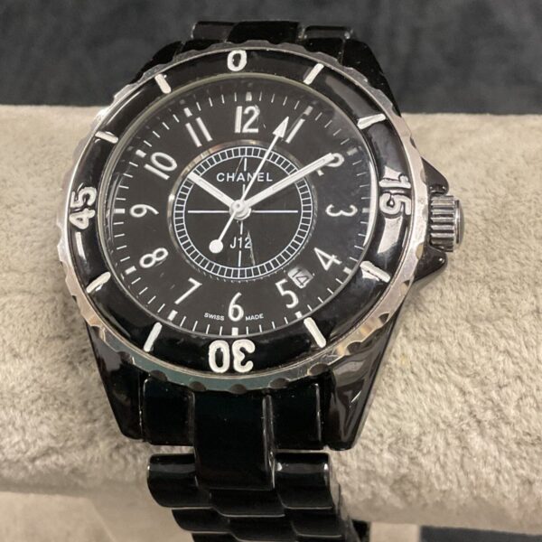 Chanel J12 black ceramic wristwatch, close-up view.