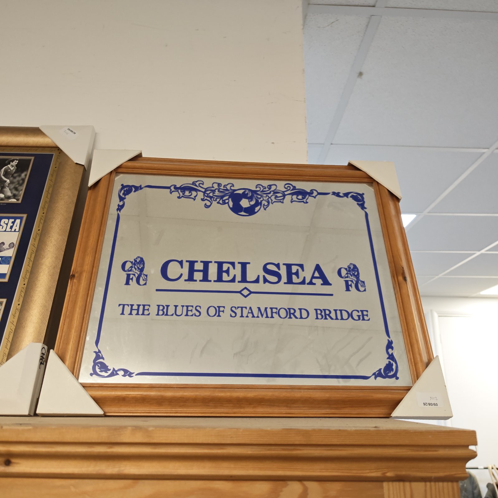 Framed Chelsea Football Club mirror with club crest.