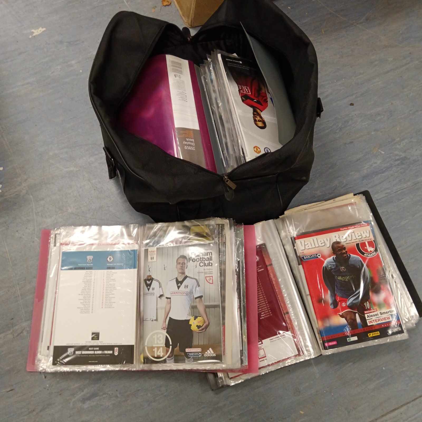Chelsea football programmes neatly organised in folders, a collectible lot.