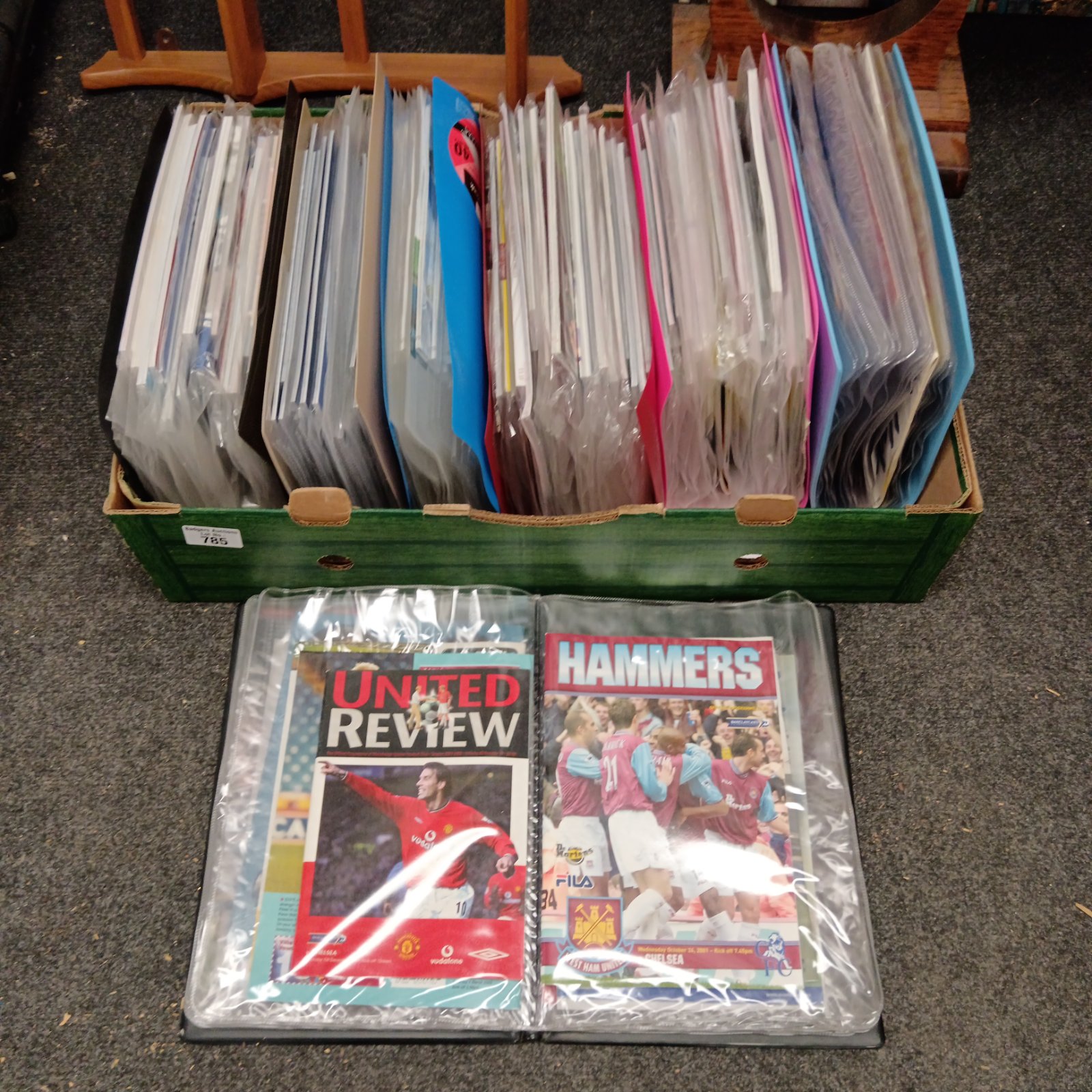 Collection of vintage Chelsea football programmes in folders.