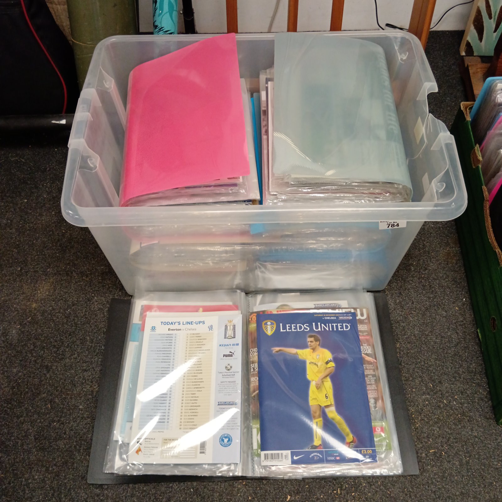Chelsea football programmes neatly organised in folders, a valuable collection.