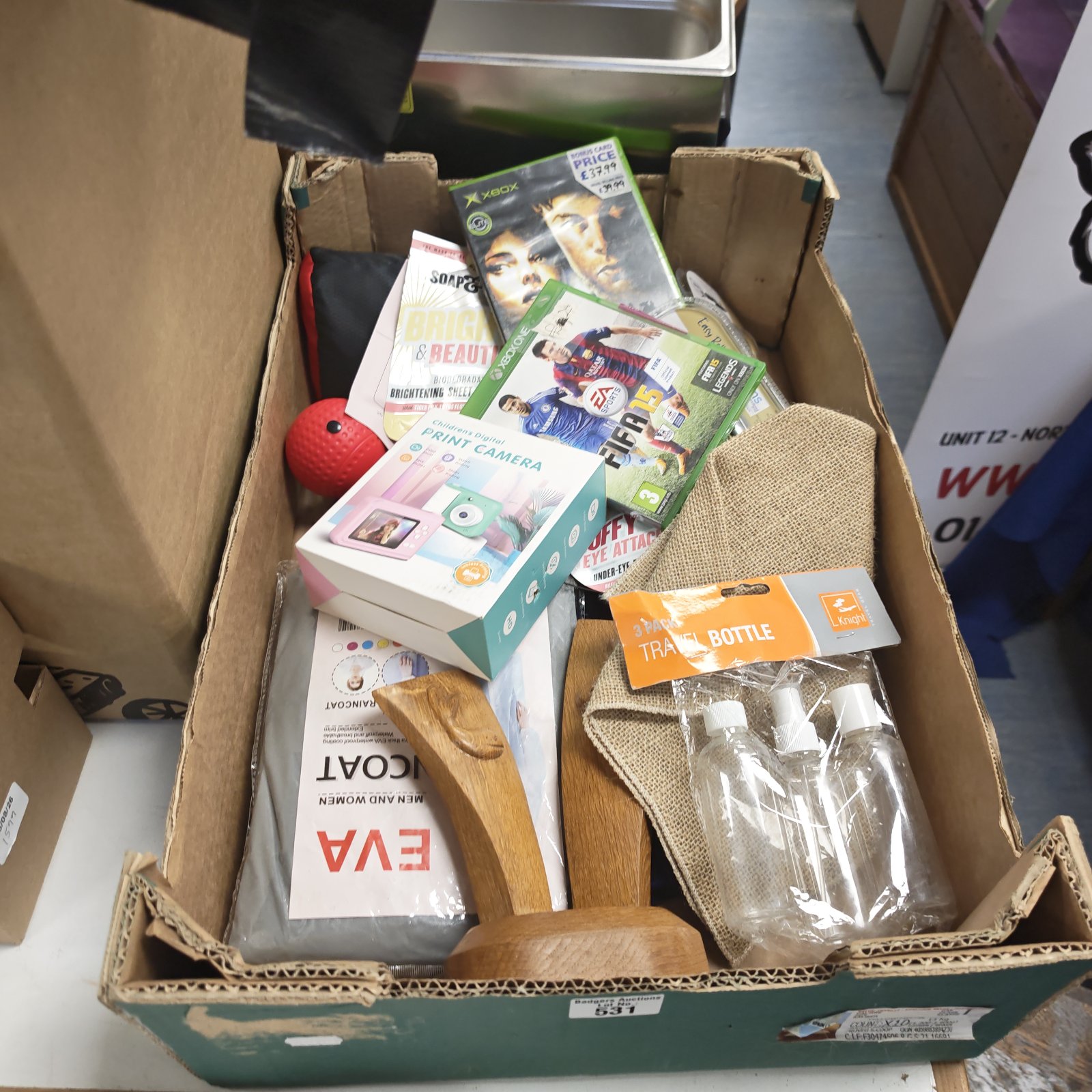 Mixed lot of children's print camera, Xbox games, and Captain America toy.