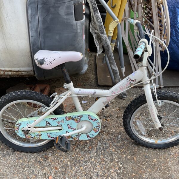 Colourful children’s butterfly bicycle in used condition.