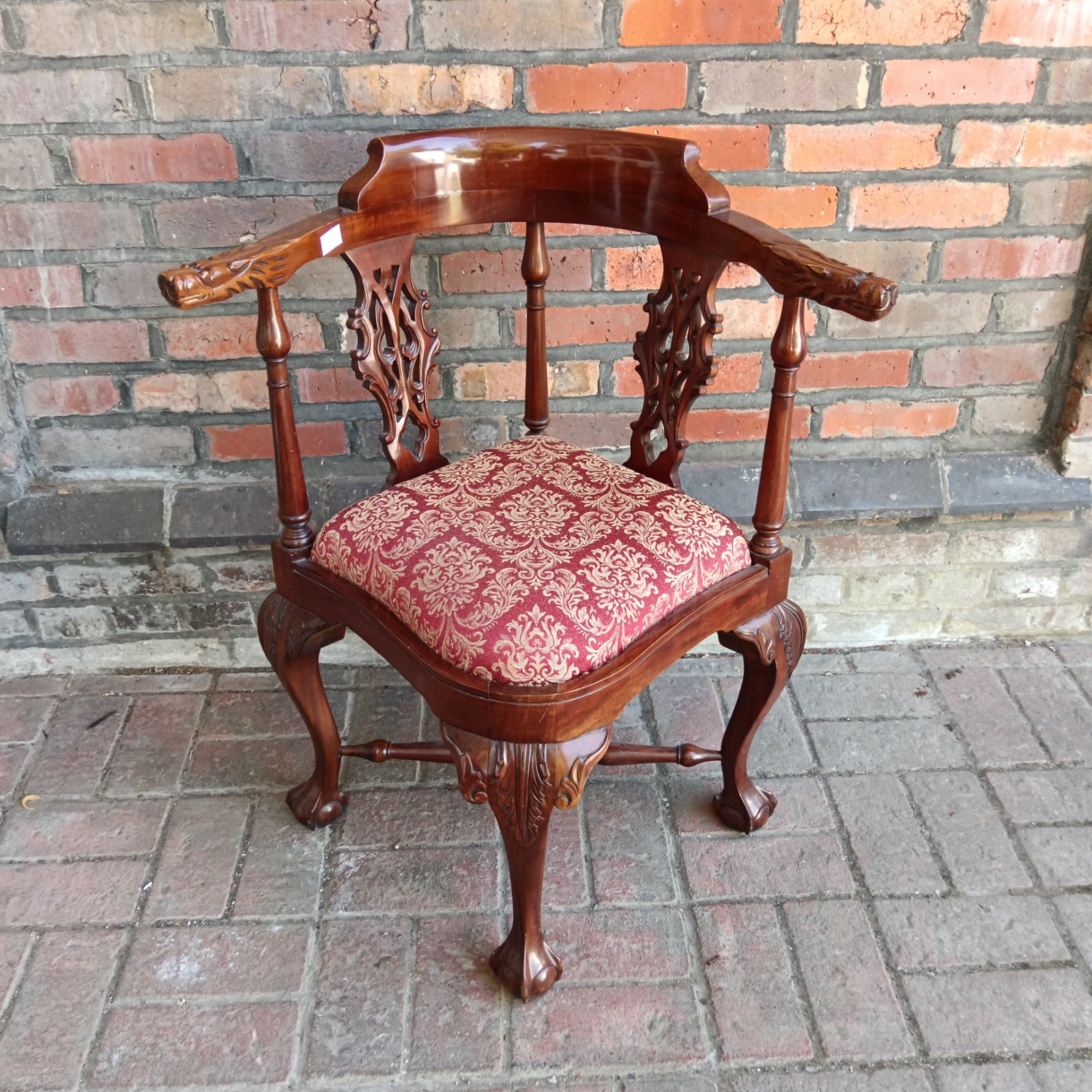 Vintage Chippendale corner chair with red patterned upholstery.