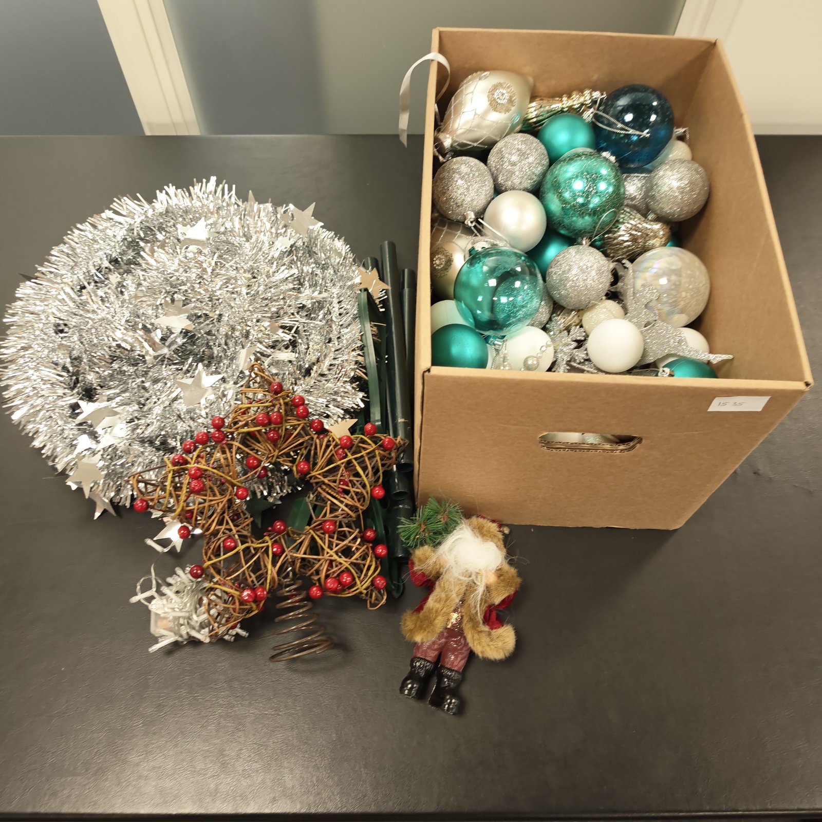 Box of vintage Christmas decorations including baubles and tinsel.
