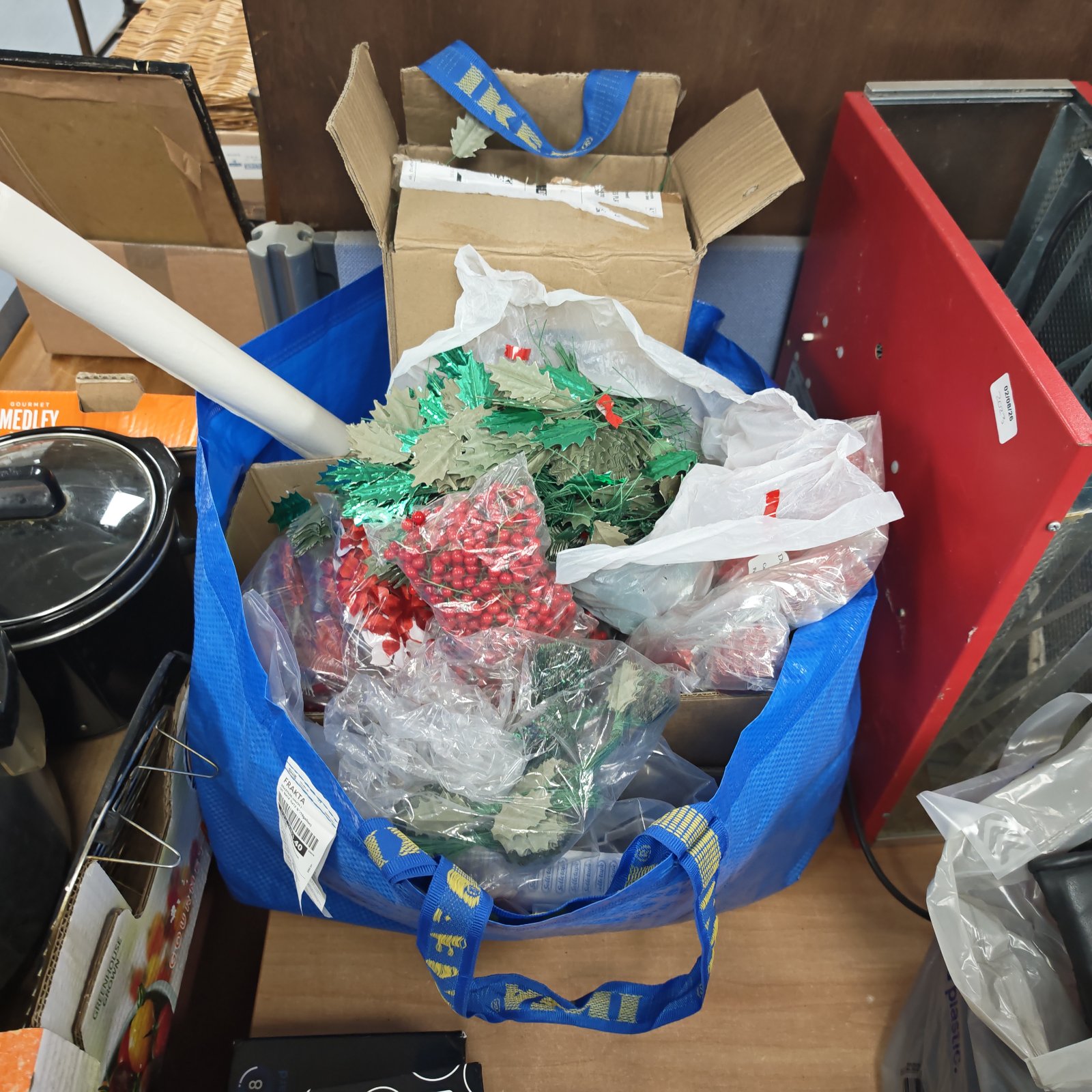 Large bag of mixed Christmas decorations with holly and berries.
