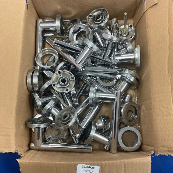 Box of vintage chrome door handles for architectural salvage.