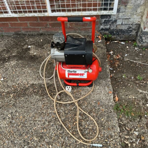 Red Clarke Pioneer 100 air compressor with tubular frame.