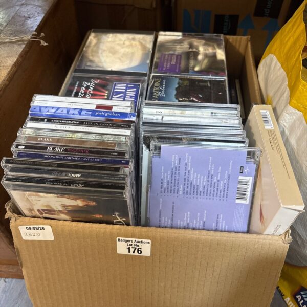Box of classical music CDs for sale, a diverse collection.