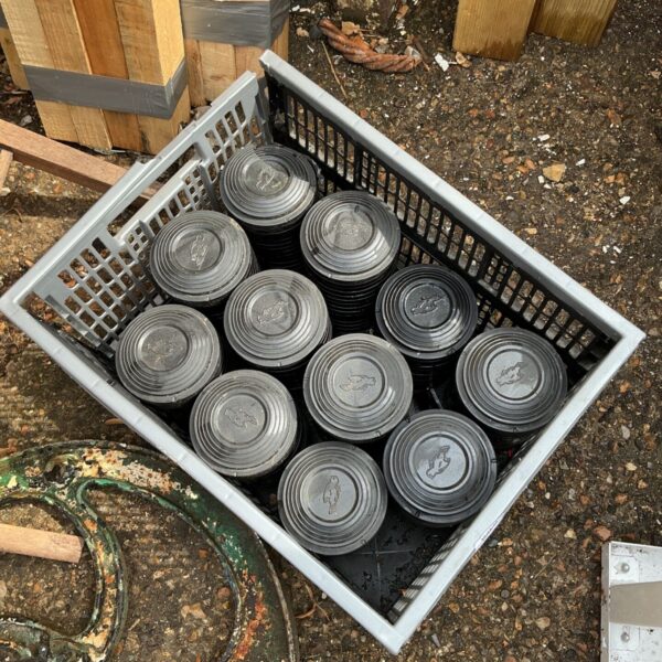 Used clay pigeon shells in a plastic crate for shooting sports.