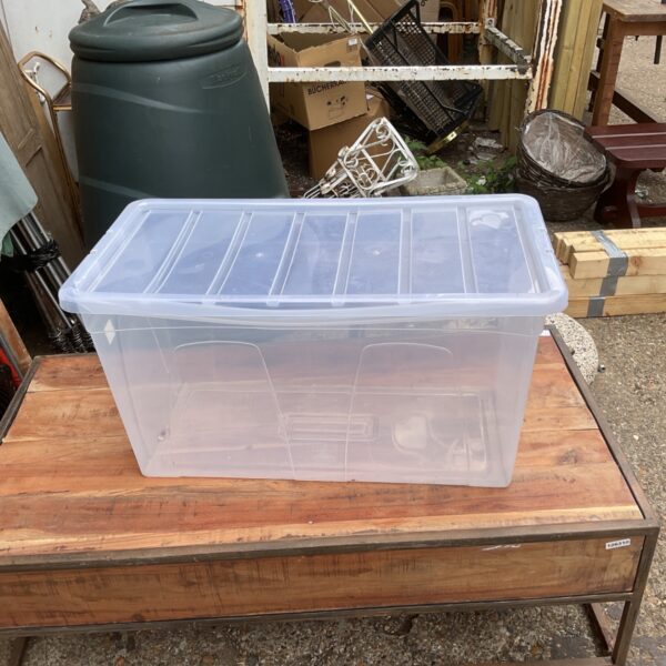 Clear plastic storage box with lid, ideal for home organization.