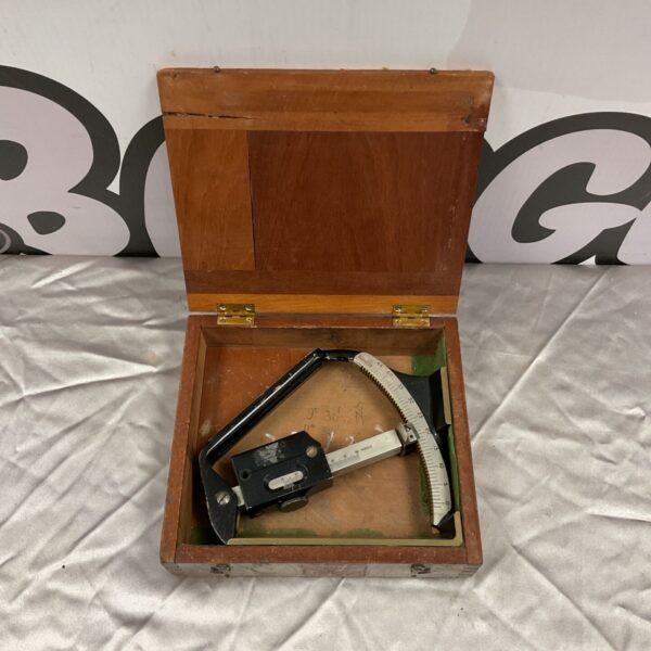 Vintage ER Watts clinometer in open wooden case.