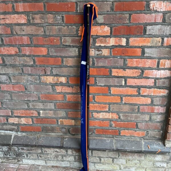 Colmic Extreme Superior fishing whip leaning against brick wall.