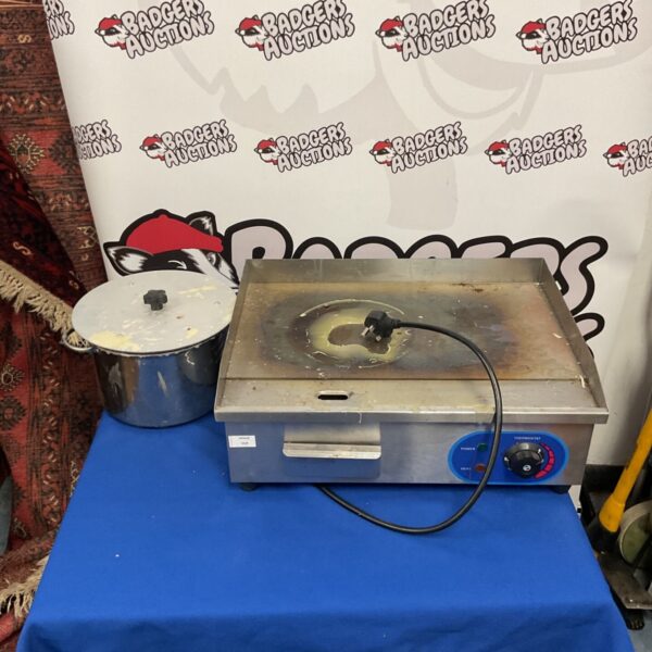 Stainless steel commercial electric griddle for restaurant use.