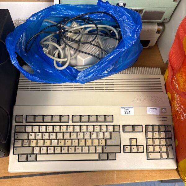 Vintage Commodore Amiga 500 computer with accessories in a bag.