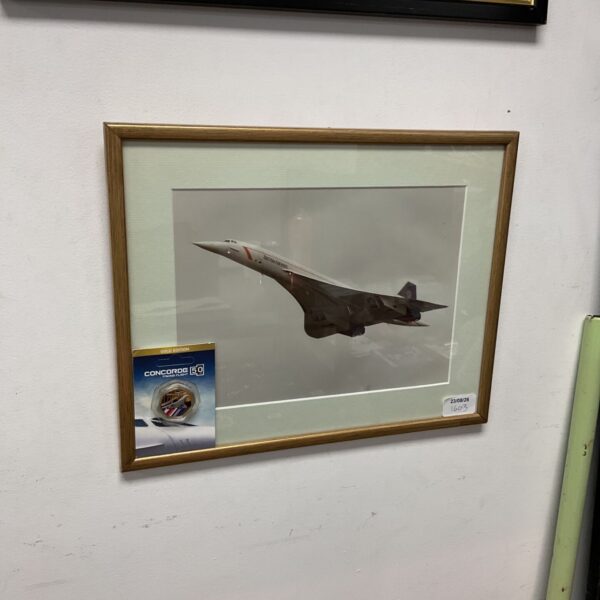 Framed Concorde photograph with a commemorative 50p coin.