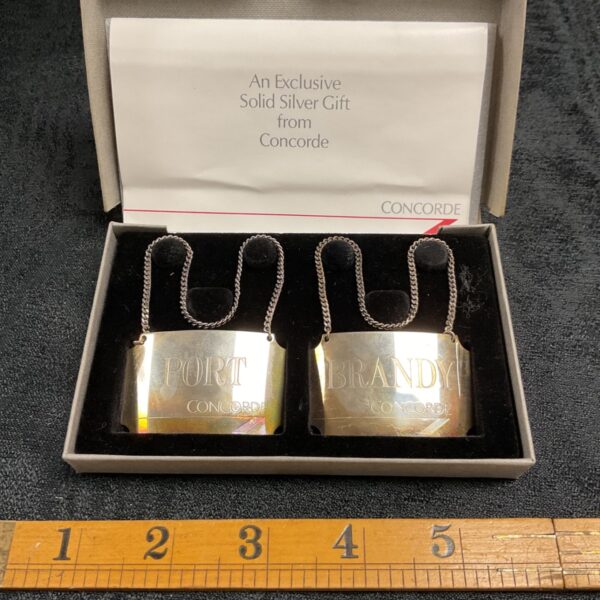 Concorde silver port and brandy bottle labels presented in original box.