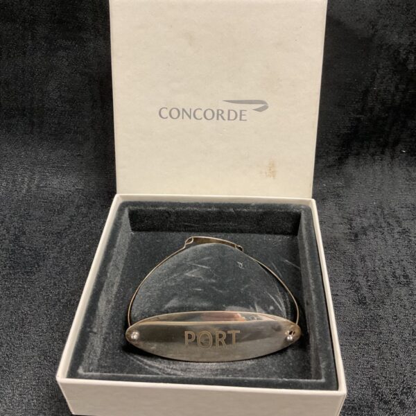 Hallmarked silver Concorde port bottle label for wine collection.